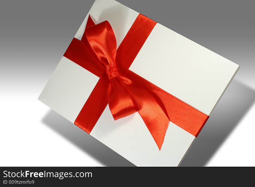 Blank white gift covered with red ribbon. Blank white gift covered with red ribbon