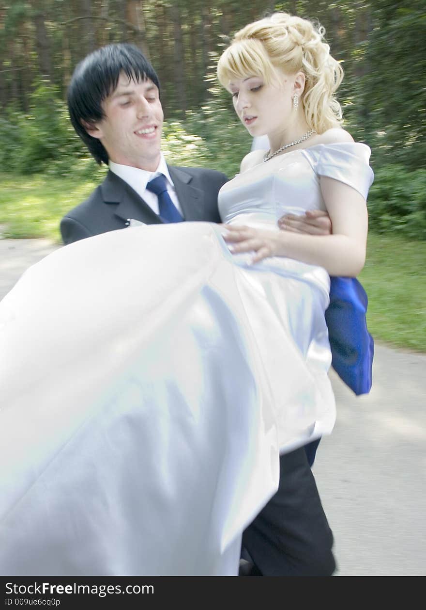 Young bride and groom at walking on after wedding ceremony