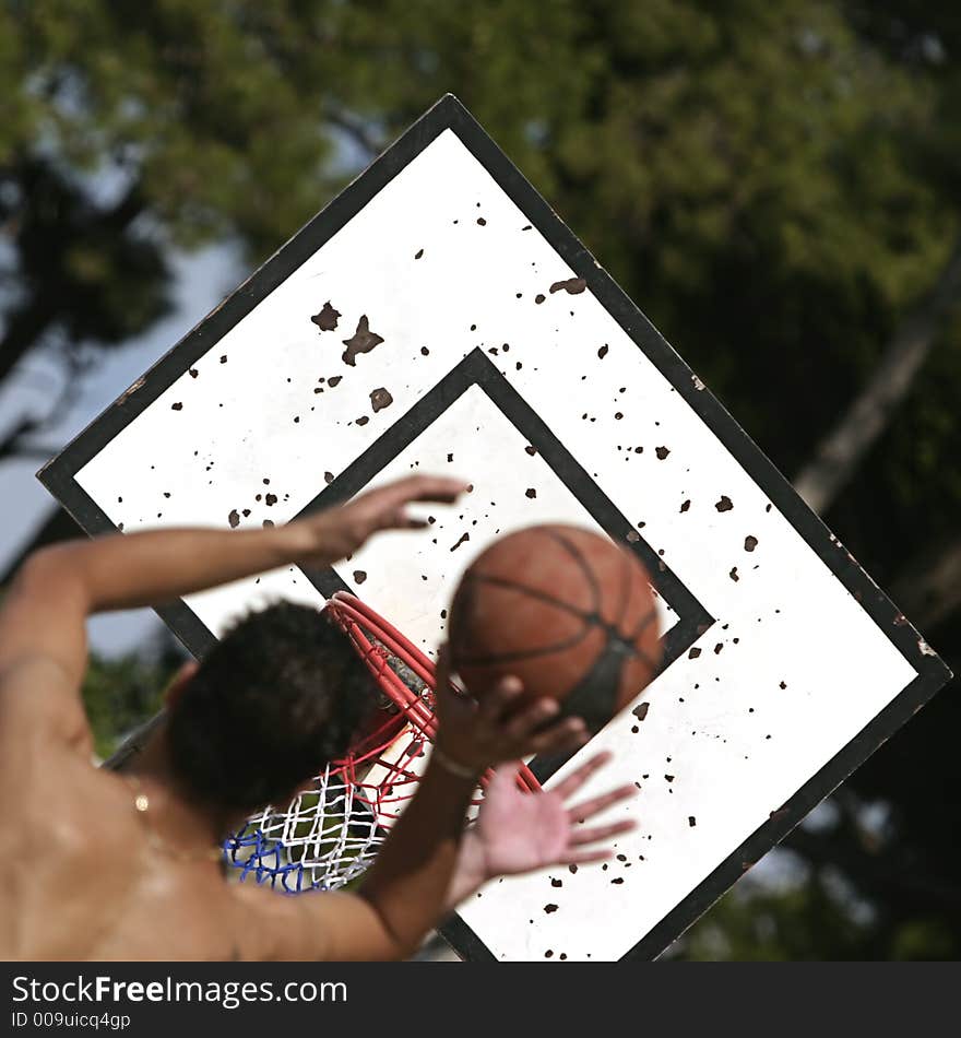 Basketball player shooting over his opponent