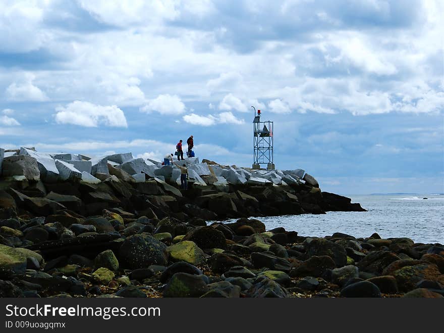 An ocean breaker of rocks at the entrance to a harbor