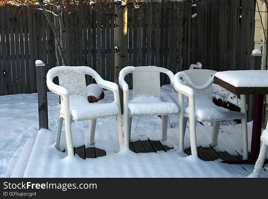 Plastic Summer Chairs in Winter with Snow