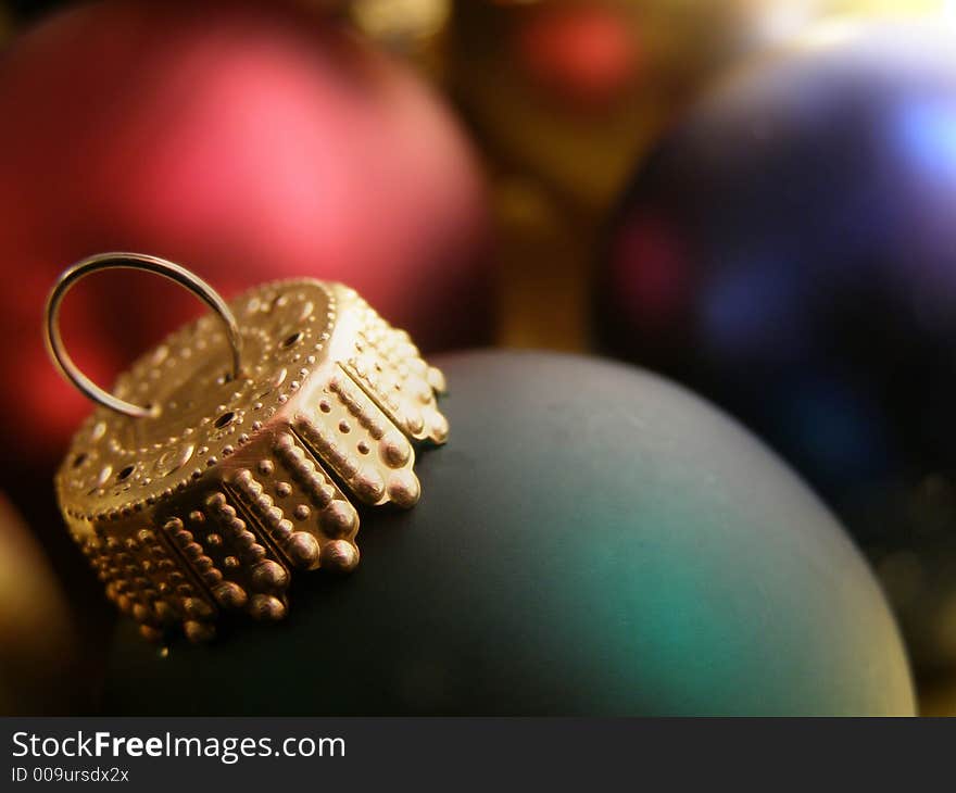 Extreme closeup of Christmas ornaments detailing the ornamental hooks.