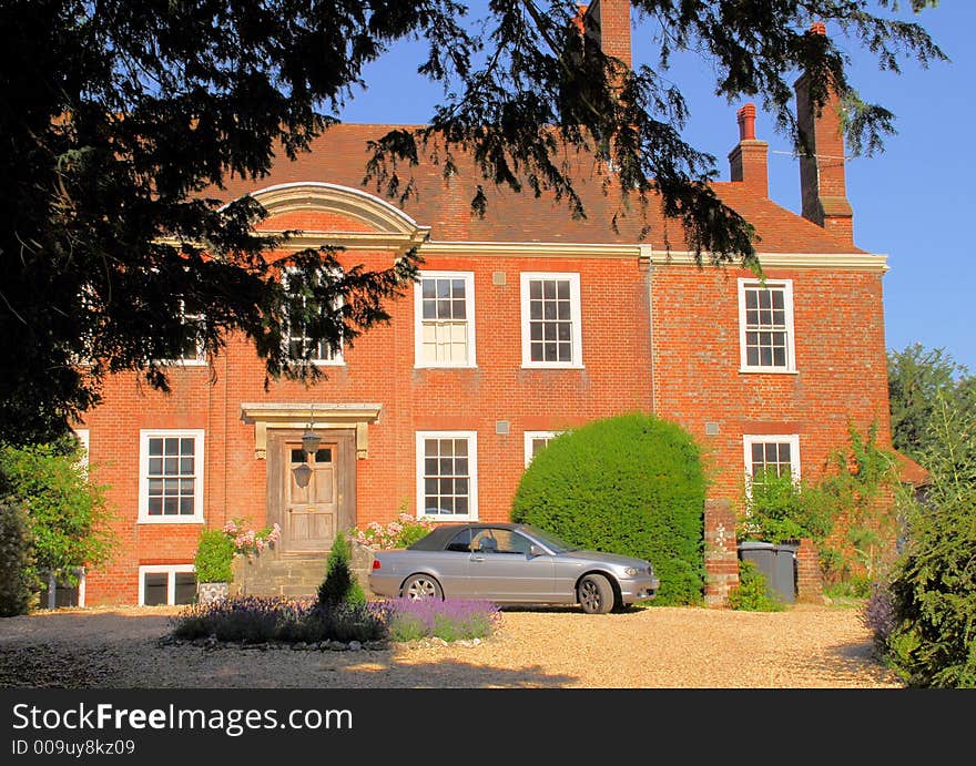 A typical English stately home in the old town of Winchester on a bright summer morning. A typical English stately home in the old town of Winchester on a bright summer morning.