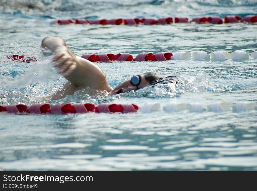 A man swimming in a pool. A man swimming in a pool