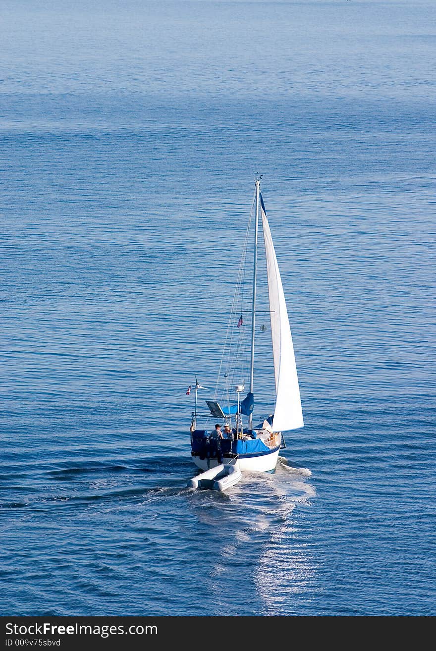 Sailboat on calm blue waters. Sailboat on calm blue waters