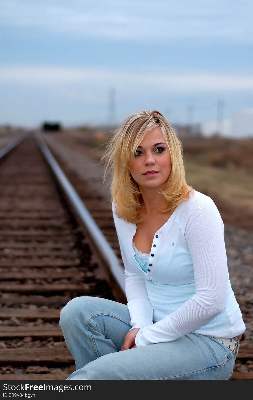 Beautiful young woman on railroad tracks. Beautiful young woman on railroad tracks.