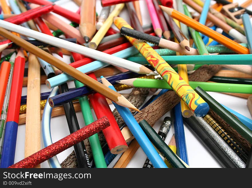 Collection of multi-colour pencils from a tree and plastic on a white table. Collection of multi-colour pencils from a tree and plastic on a white table