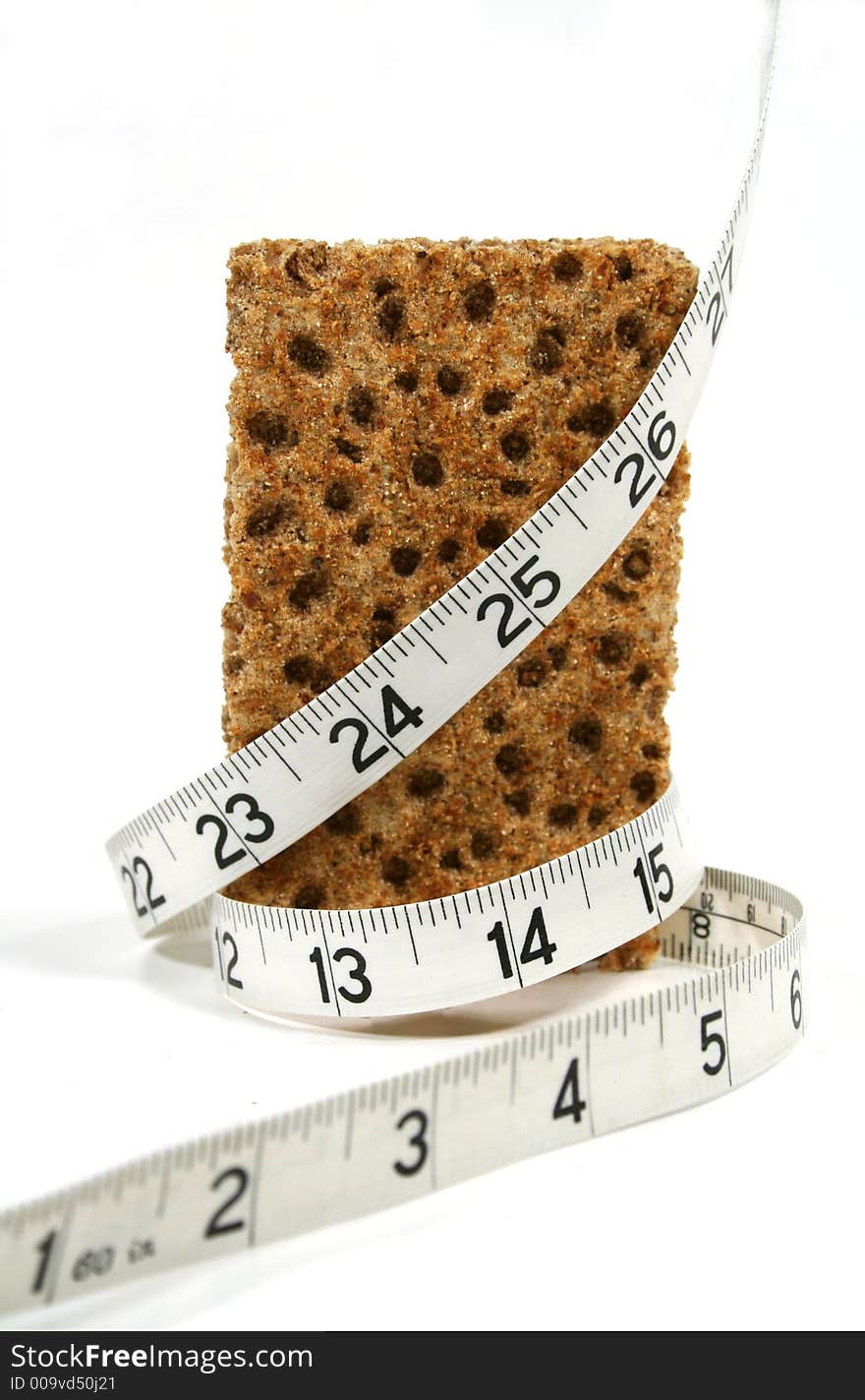 Low calorie rye cracker wrapped in a tape measure. Low calorie rye cracker wrapped in a tape measure.