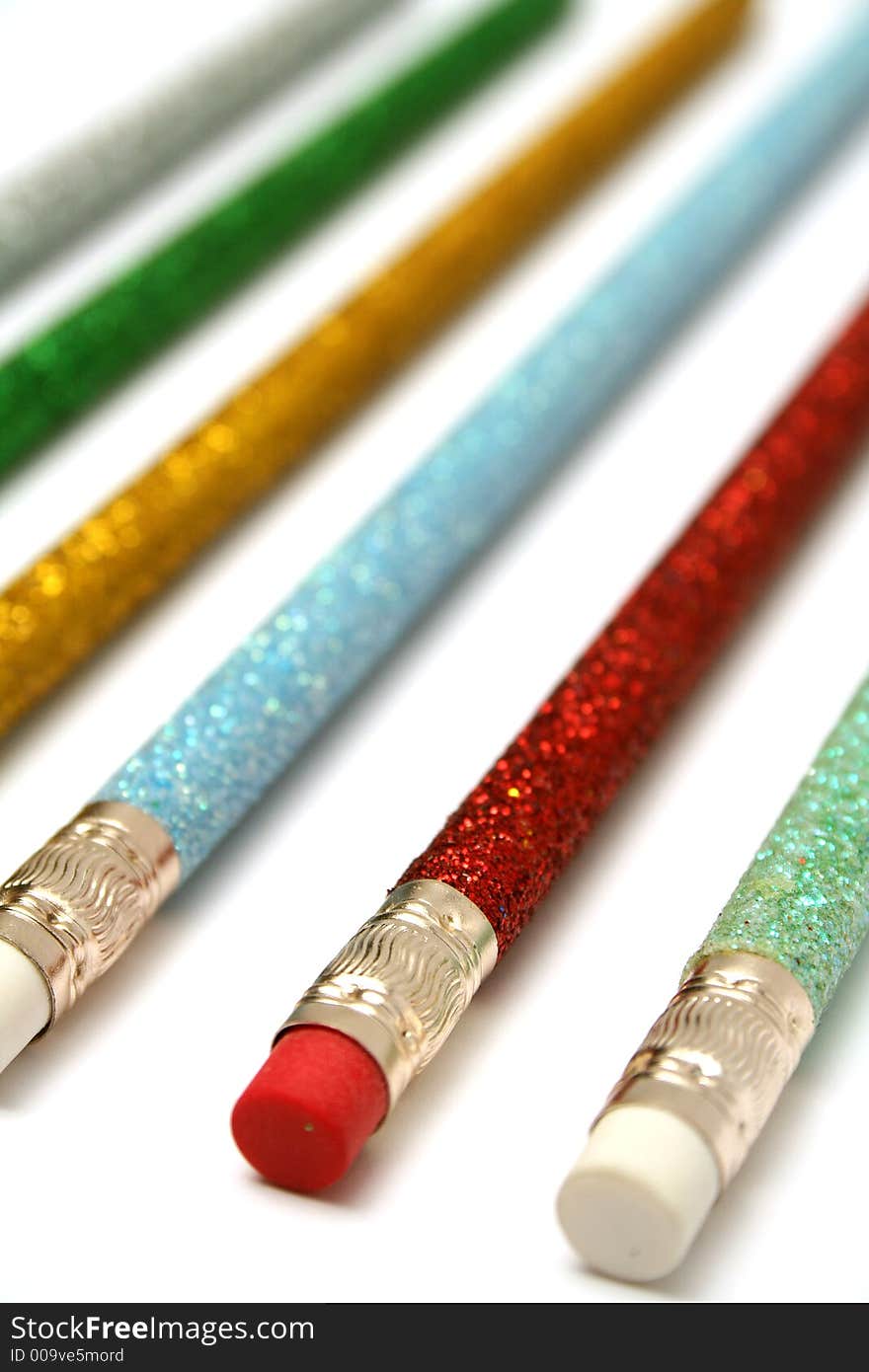 Set of celebratory color pencils with a multi-coloured sparkling covering macro. Set of celebratory color pencils with a multi-coloured sparkling covering macro