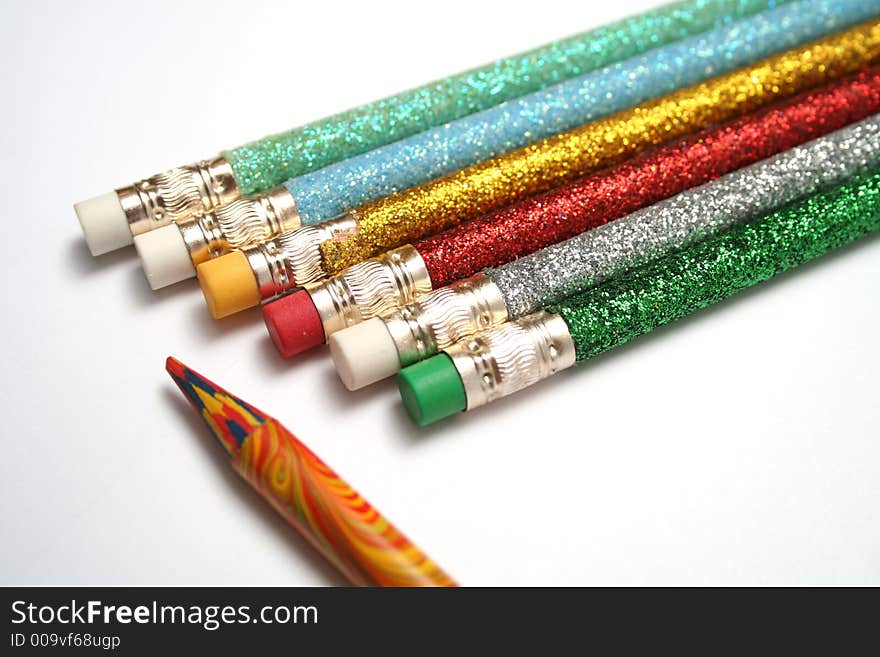 Set of celebratory pencils about a multi-colour pencil on a diagonal