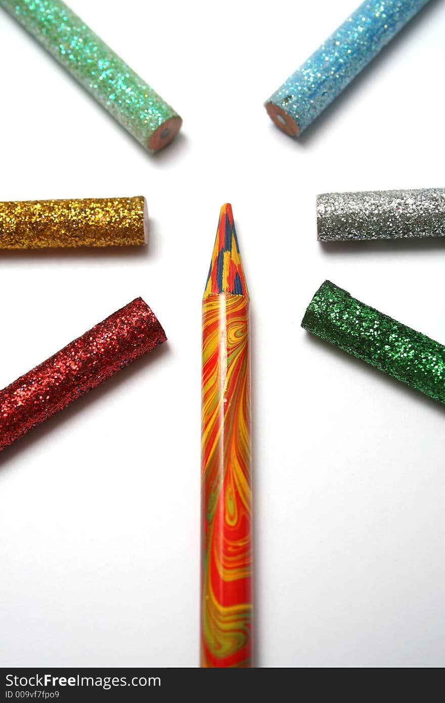 The multi-colour pencil is surrounded by brilliant color pencils