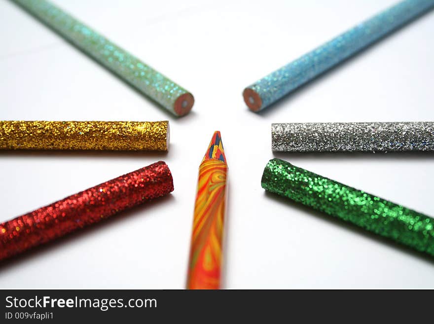 The multi-colour pencil is surrounded by brilliant color pencils from above macro. The multi-colour pencil is surrounded by brilliant color pencils from above macro