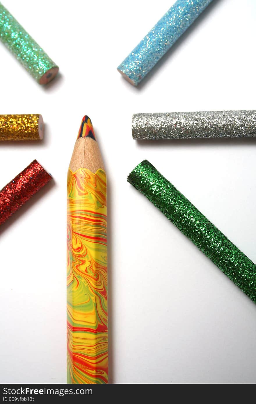 The multi-colour big pencil is surrounded by brilliant color pencils from above. The multi-colour big pencil is surrounded by brilliant color pencils from above