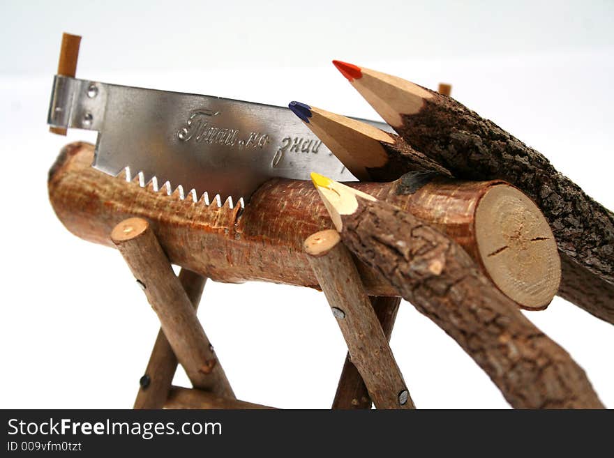 Three color pencils made of branches glad with a saw