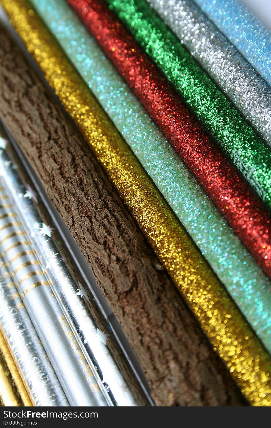 Unusual pencil made of natural wood among multi-coloured sparkling pencils vertical. Unusual pencil made of natural wood among multi-coloured sparkling pencils vertical