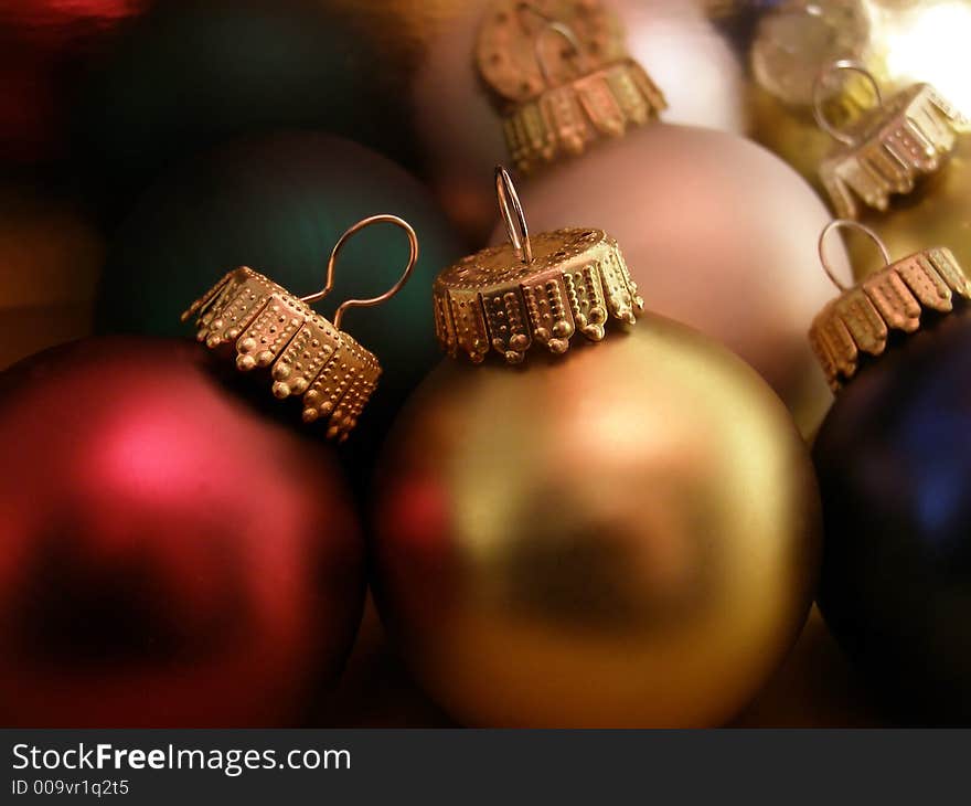 Extreme closeup of Christmas ornaments detailing the ornamental hooks.