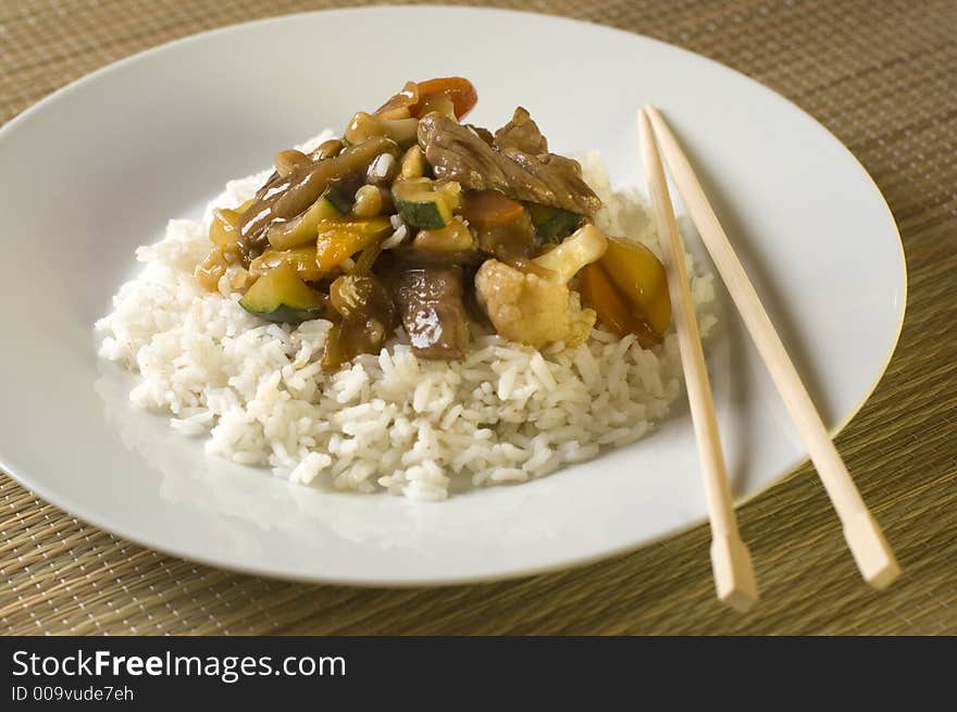 Beef china food gravy with rice on white plate