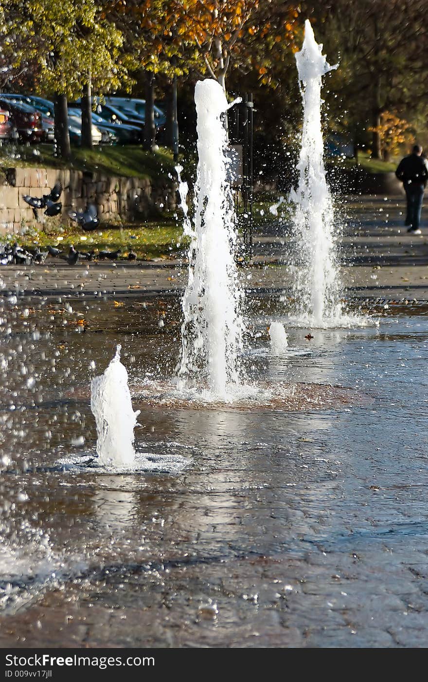 A path level fountain dancing in the sunshine. A path level fountain dancing in the sunshine.