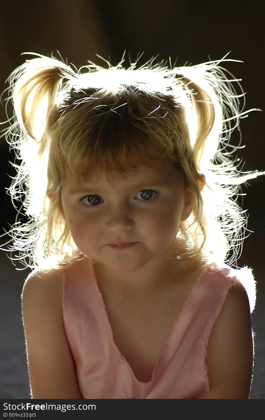 Beautiful back-lit little girl with blond hair. Beautiful back-lit little girl with blond hair