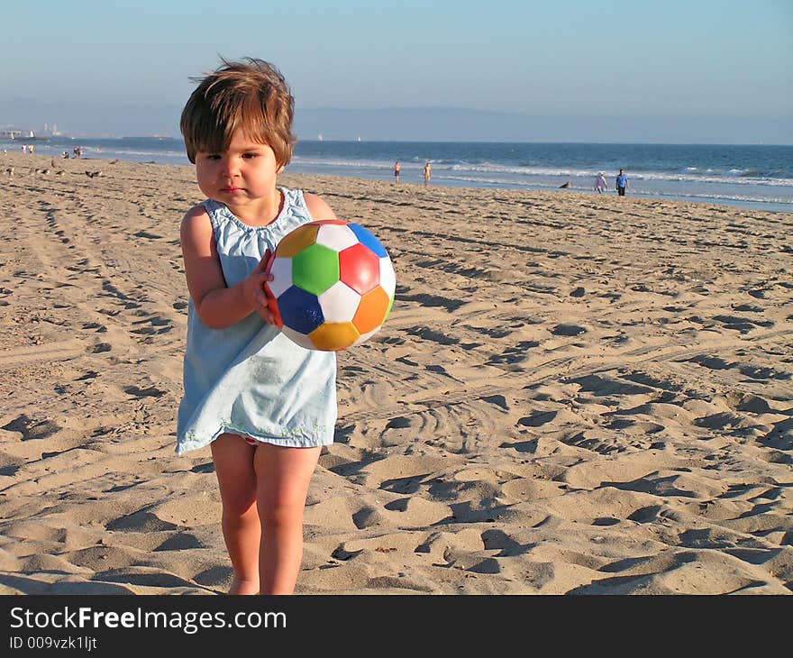 Girl playing at the beach