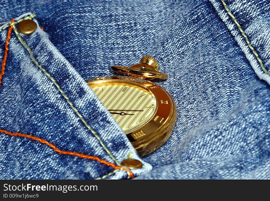 Golden pocket watch in back pocket of jean. Golden pocket watch in back pocket of jean