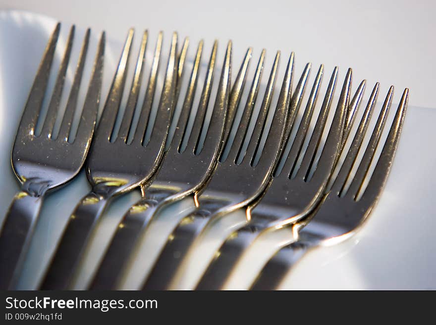 Stainless steel forks in a line. Stainless steel forks in a line.