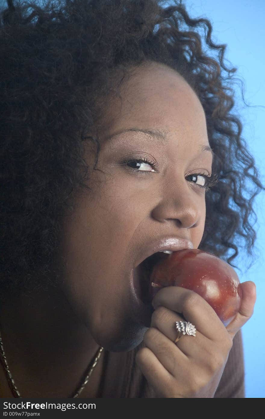 Close up of a girl eating an apple