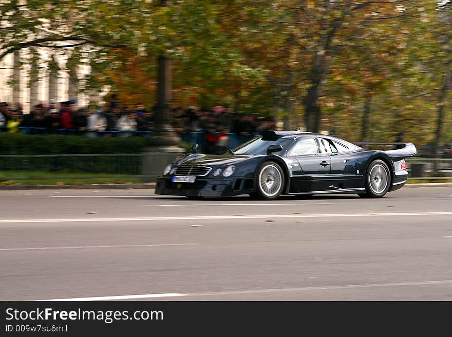 Black car speeding on the road. Black car speeding on the road.