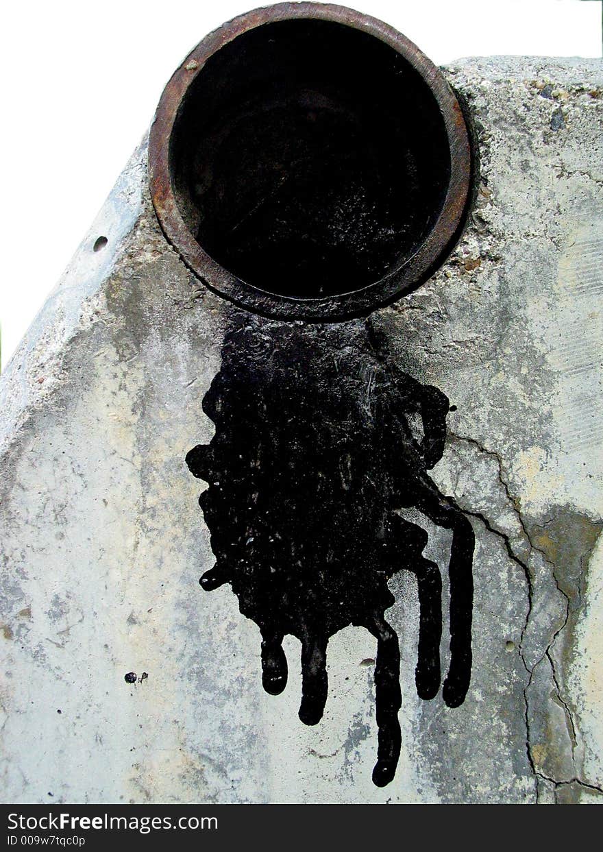 Description: A shot of the opening at the end of a black pipe sitting directly above white concrete.  Black paint is dripping from the pipe onto the concrete. Description: A shot of the opening at the end of a black pipe sitting directly above white concrete.  Black paint is dripping from the pipe onto the concrete.