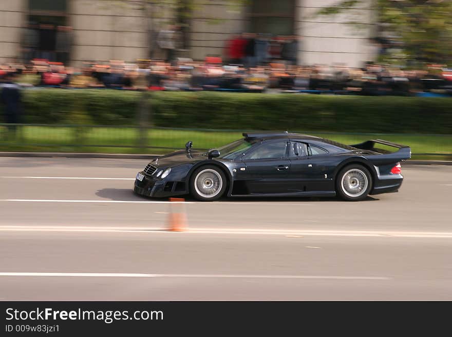 Black race power car driving on the road. Black race power car driving on the road