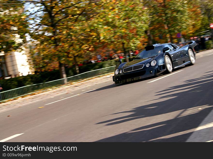 Black speed race roadster on the road. Black speed race roadster on the road