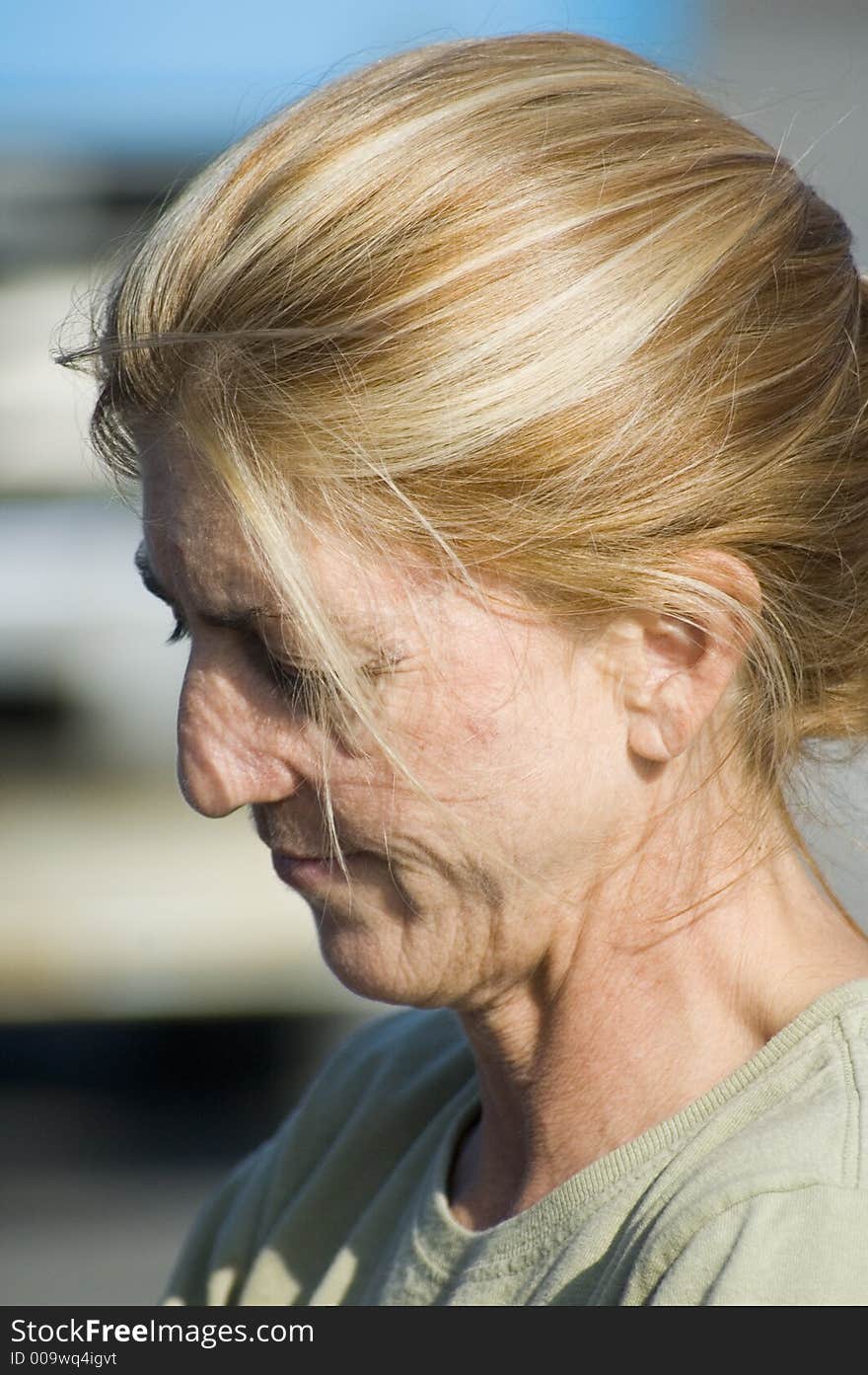 A woman side profile with hair pulled back. A woman side profile with hair pulled back