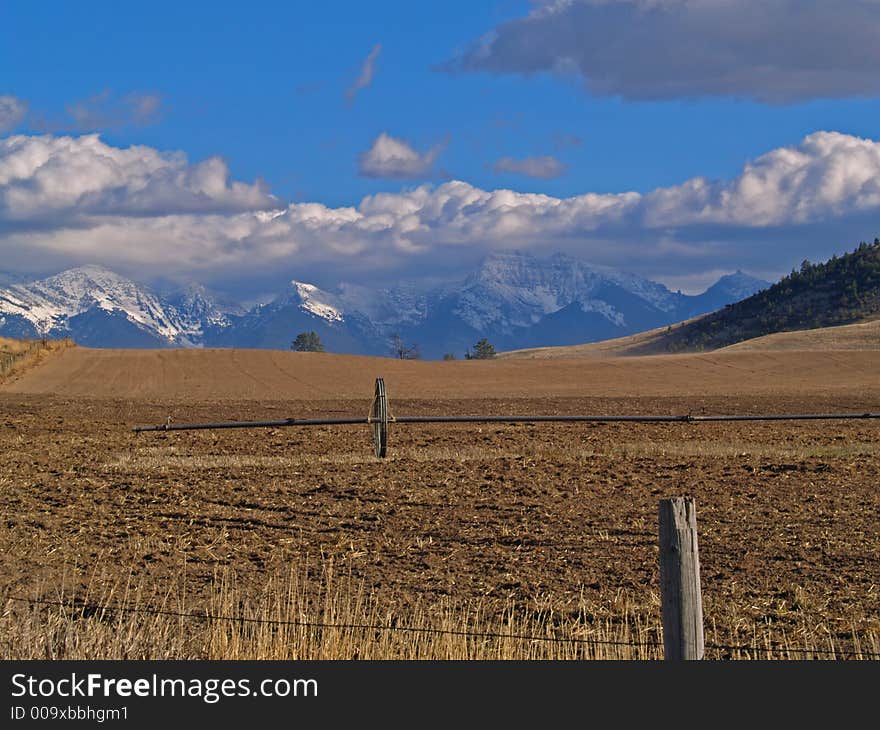 Field, Irrigation Pipe and Mountains