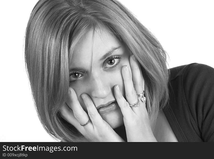 A black and white picture of a woman with her hands on her cheeks in surprise. A black and white picture of a woman with her hands on her cheeks in surprise.