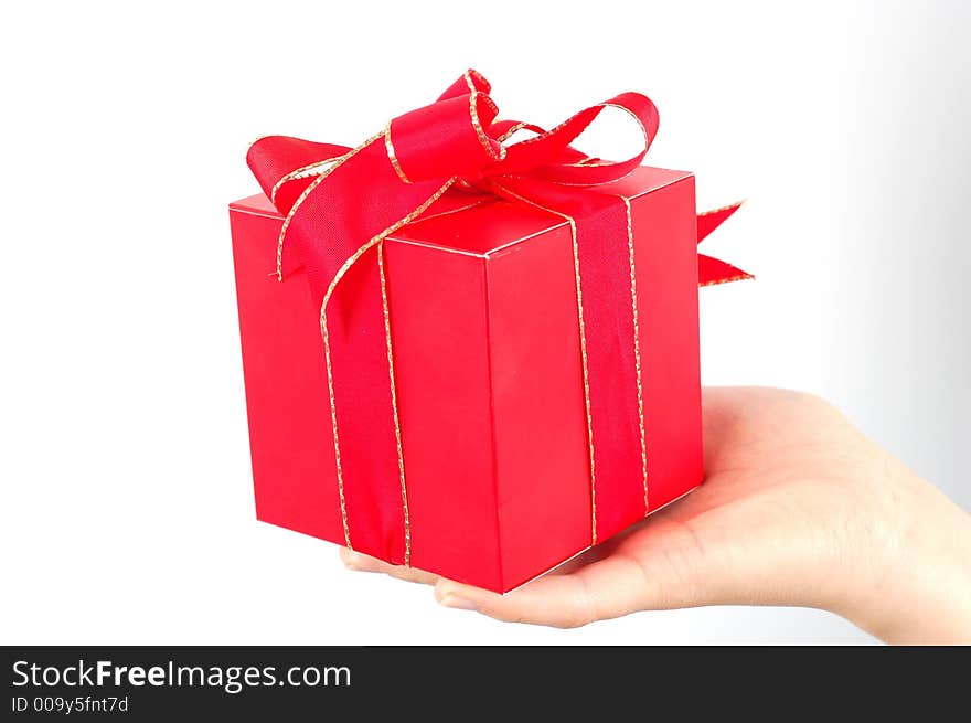 Red gift with red ribbon and bow on white background. Red gift with red ribbon and bow on white background