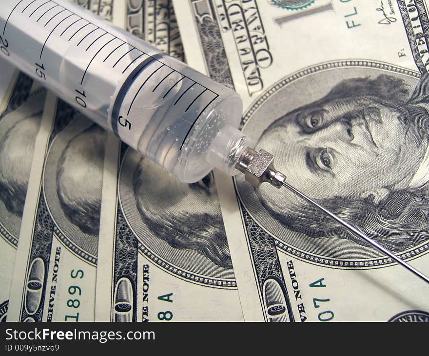 Syringe on money