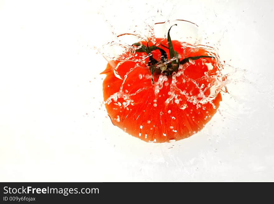 Tomato splashing in water