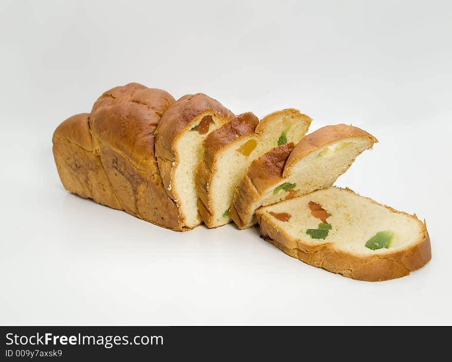 Sliced sponge cake dessert over white background