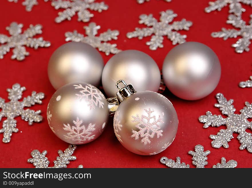 Silver christmas ornaments on red. Silver christmas ornaments on red