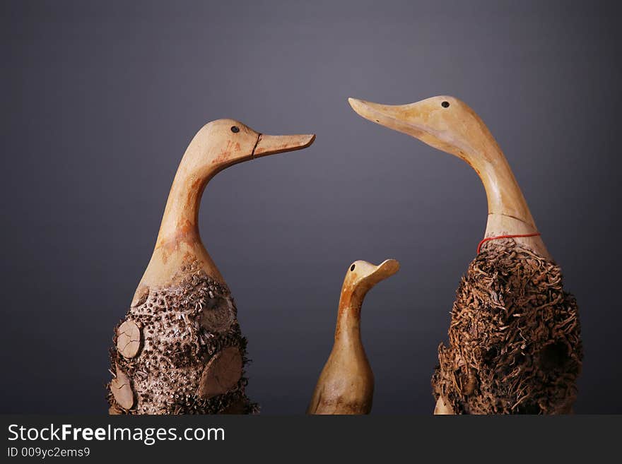 Wooden ducks shot over gray background. Wooden ducks shot over gray background