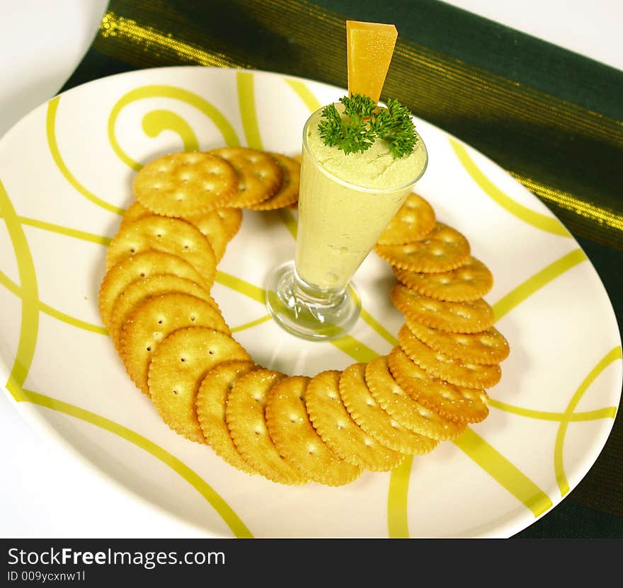 Guacomole from avocados served with round crackers. Guacomole from avocados served with round crackers