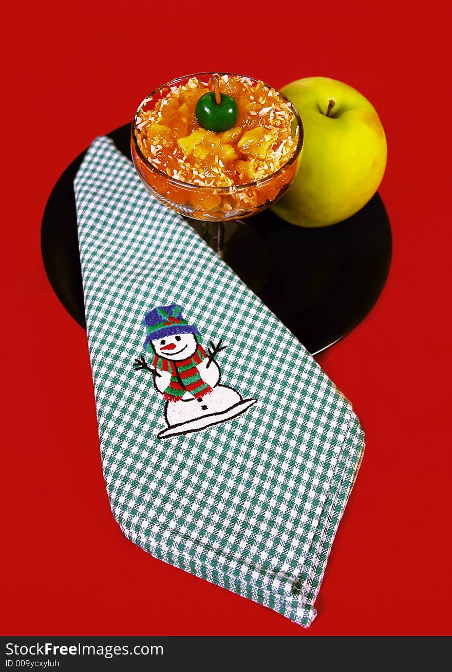 Christmas apple desert with green cherry decoration