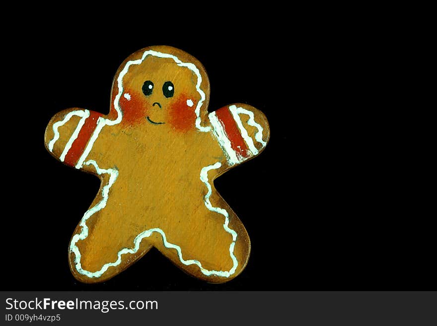 Gingerbread man as a child isolated on black space with room for text. Gingerbread man as a child isolated on black space with room for text