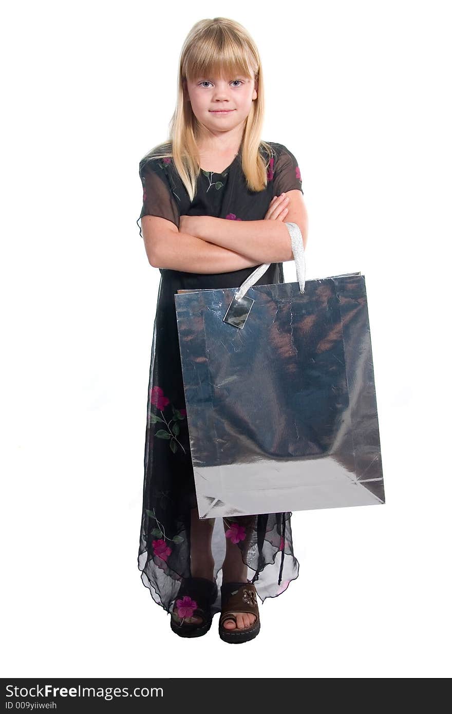 Young girl with shopping/gift bag and a content,satisfied,proud expression in black dress shot over white background. Young girl with shopping/gift bag and a content,satisfied,proud expression in black dress shot over white background.