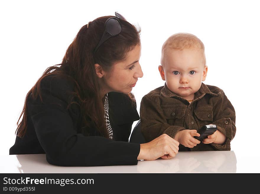 Mother looking at her baby-son which is holding a cell-phone. Mother looking at her baby-son which is holding a cell-phone