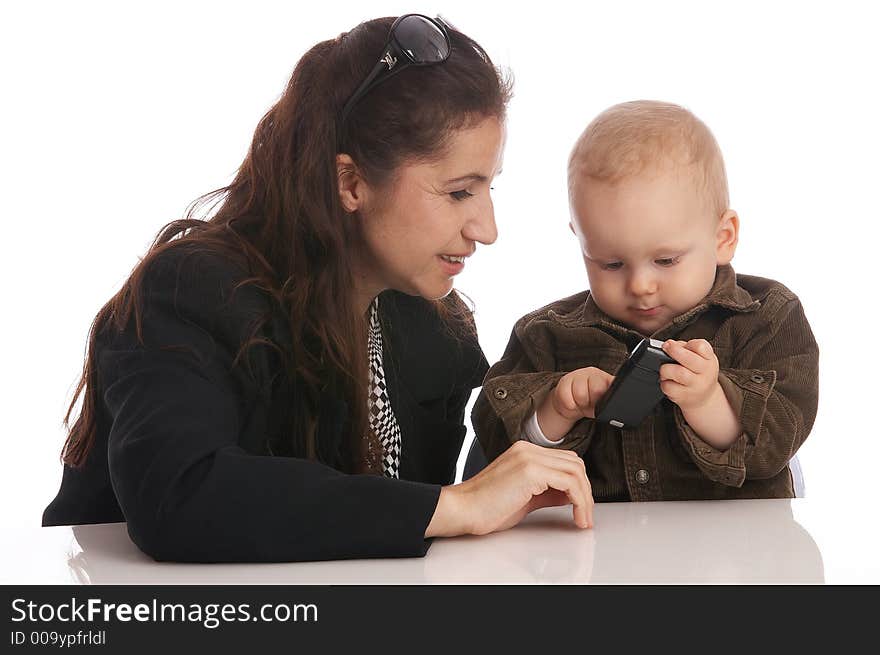 Mother and her baby-boy looking at a cell-phone. Mother and her baby-boy looking at a cell-phone