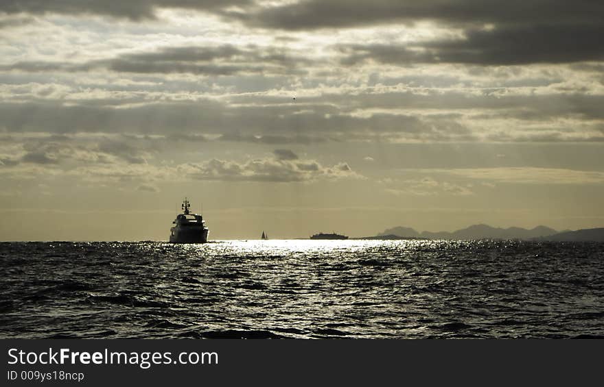 Motor yacht Teddy advancing on a roughening late afternoon sea at Cap Ferrat