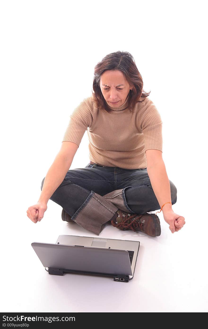 Woman sitting down on floor annoyed with something with a laptop over white background. Woman sitting down on floor annoyed with something with a laptop over white background