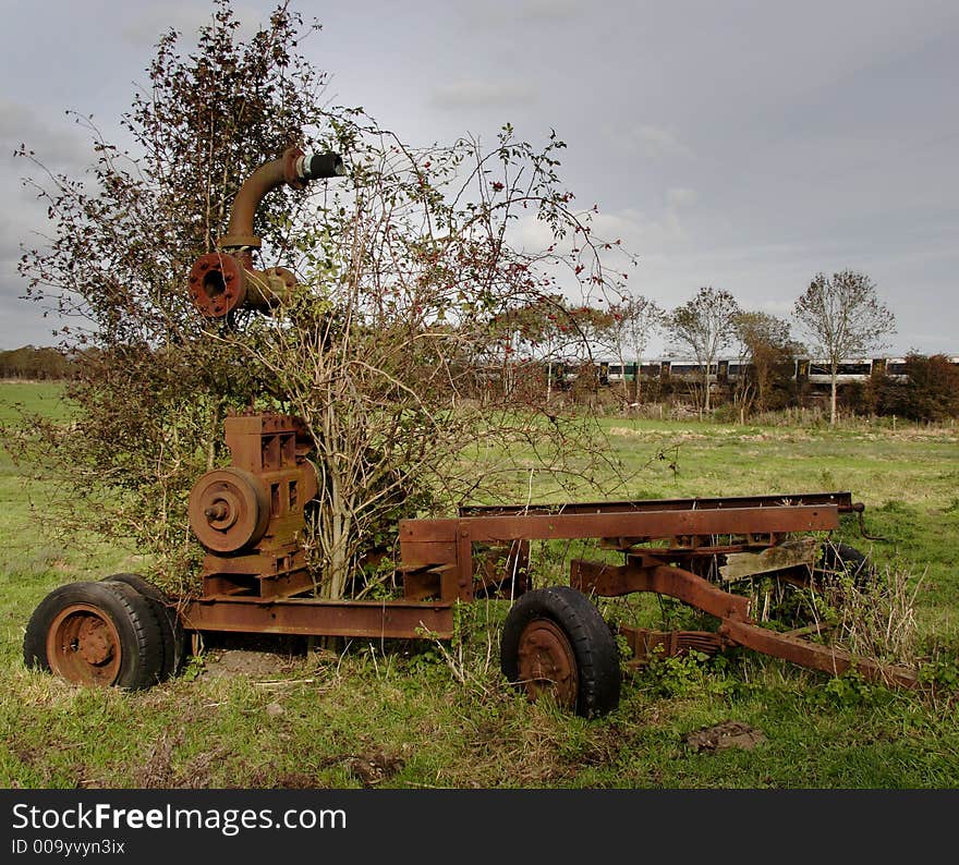 Derelict and rusting agricultural machine abandoned in an English Water Meadow. Derelict and rusting agricultural machine abandoned in an English Water Meadow.