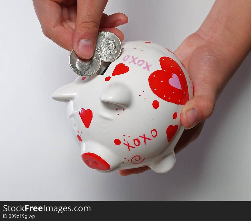 kid hands with piggy bank on white background